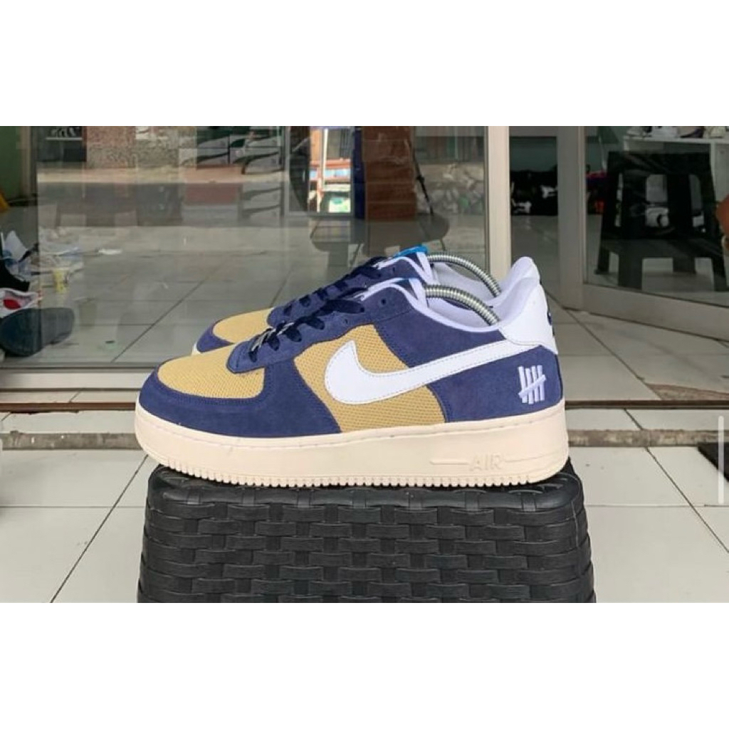 a Nike Air Force 1 Low SP x Undefeated 5 On It in the Blue Yellow Croc colorway