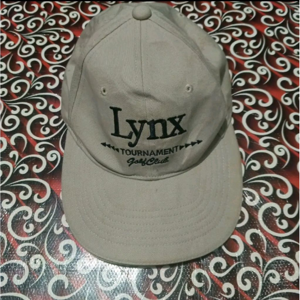 topi golf brand lynx coklat