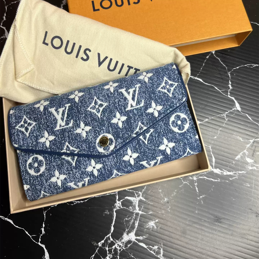 Dompet panjang wanita Louis Vuitton Sarah M81183 edisi denim eksklusif, warna biru dengan aksen kanc