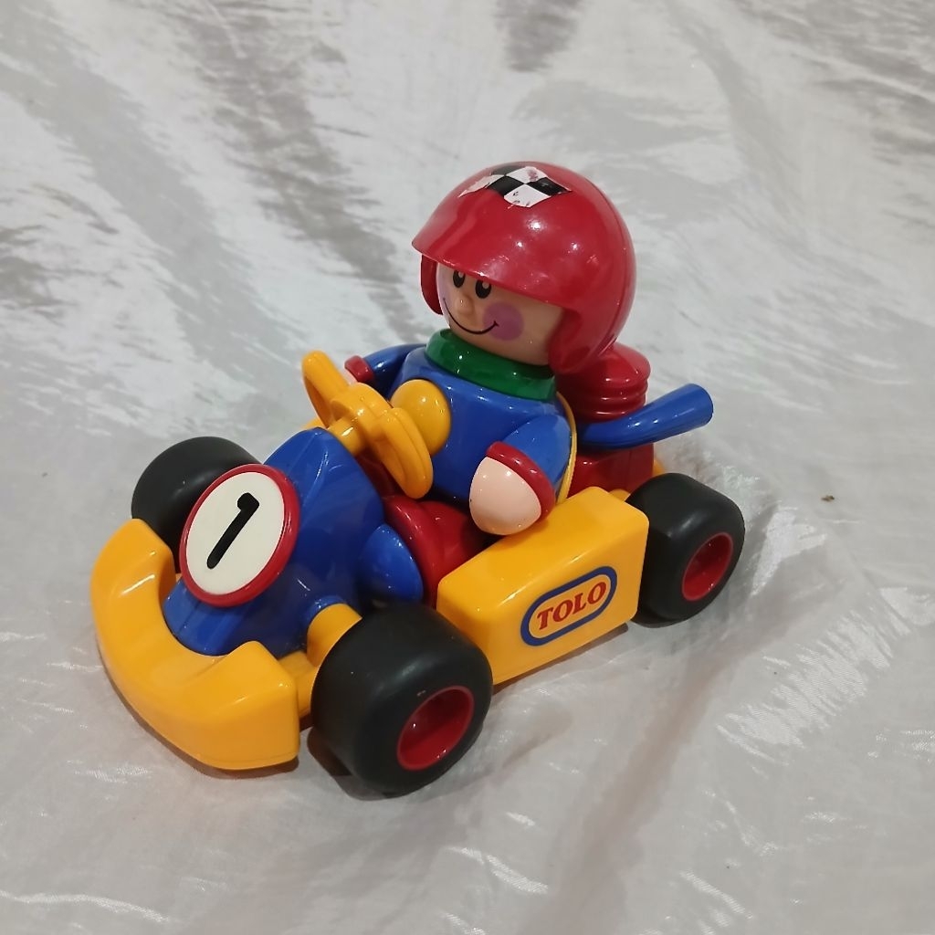 Mainan Preloved Tolo Toys First Friends Go Kart, featuring a bright yellow chassis and a removable d