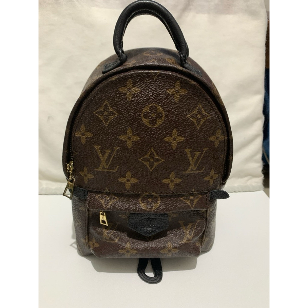 Mini Backpack in canvas with black leather trim.