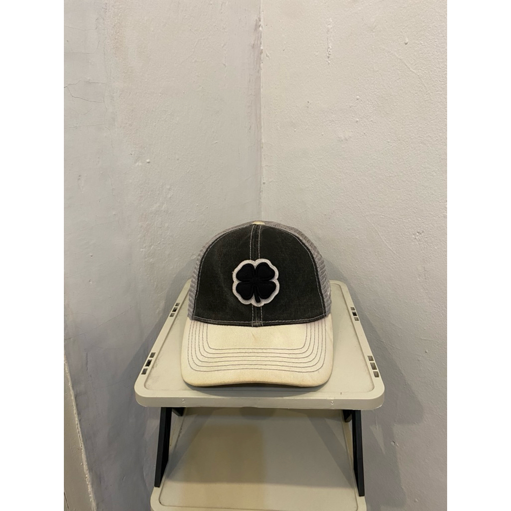Black clover trucker hat