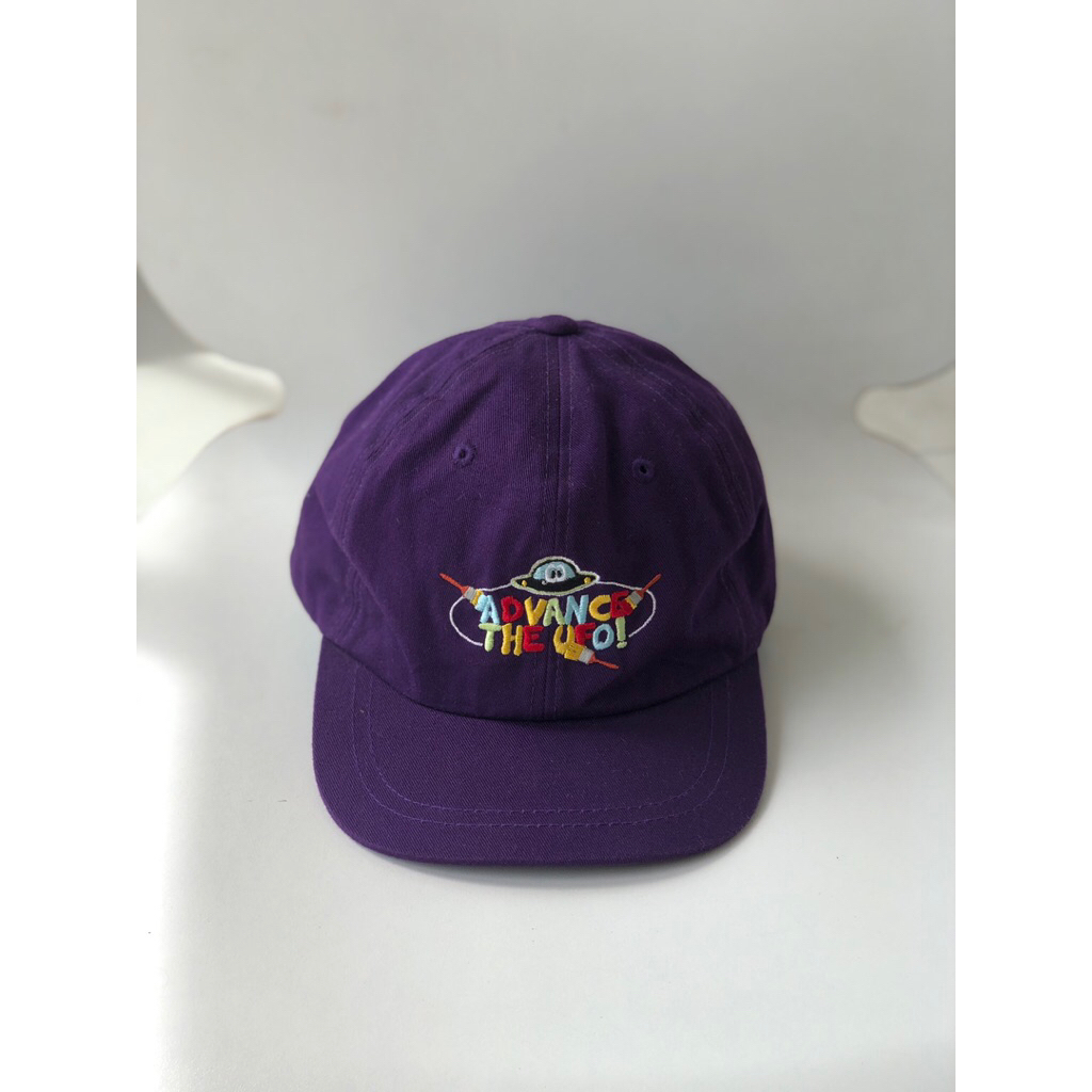 Purple Baseball Cap with UFO embroidery and the words "ADVANCE THE UFO"