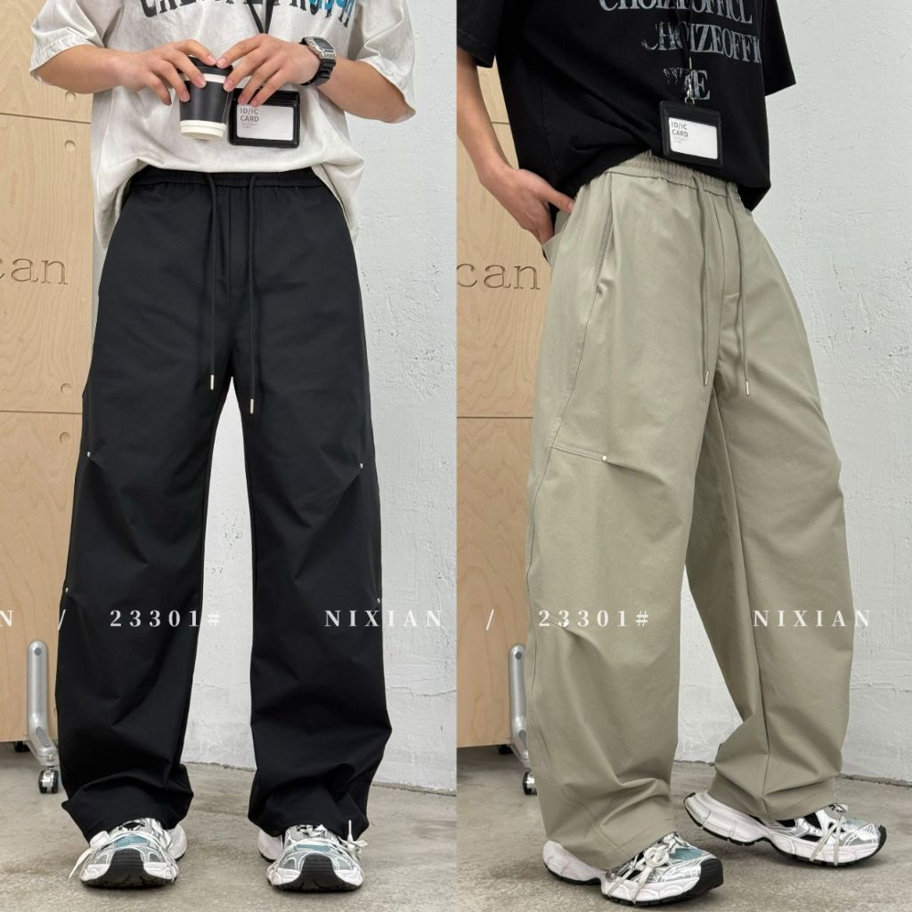 Celana Panjang black Nixian baggy cargo pants with an elastic drawstring waist and rivet details