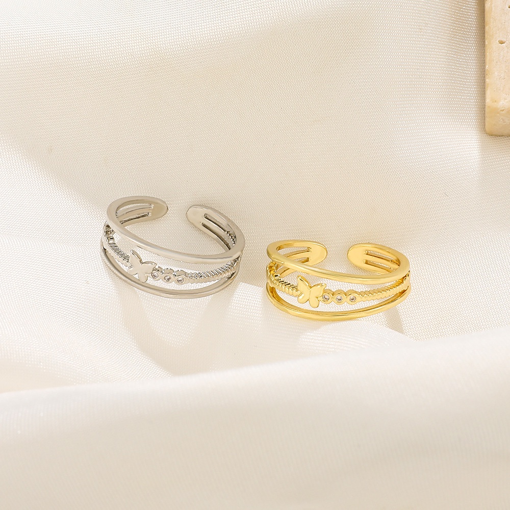 Cincin Model Terbuka Tiga Lapis Desain Kupu-Kupu Hollow Warna Emas Bahan Metal