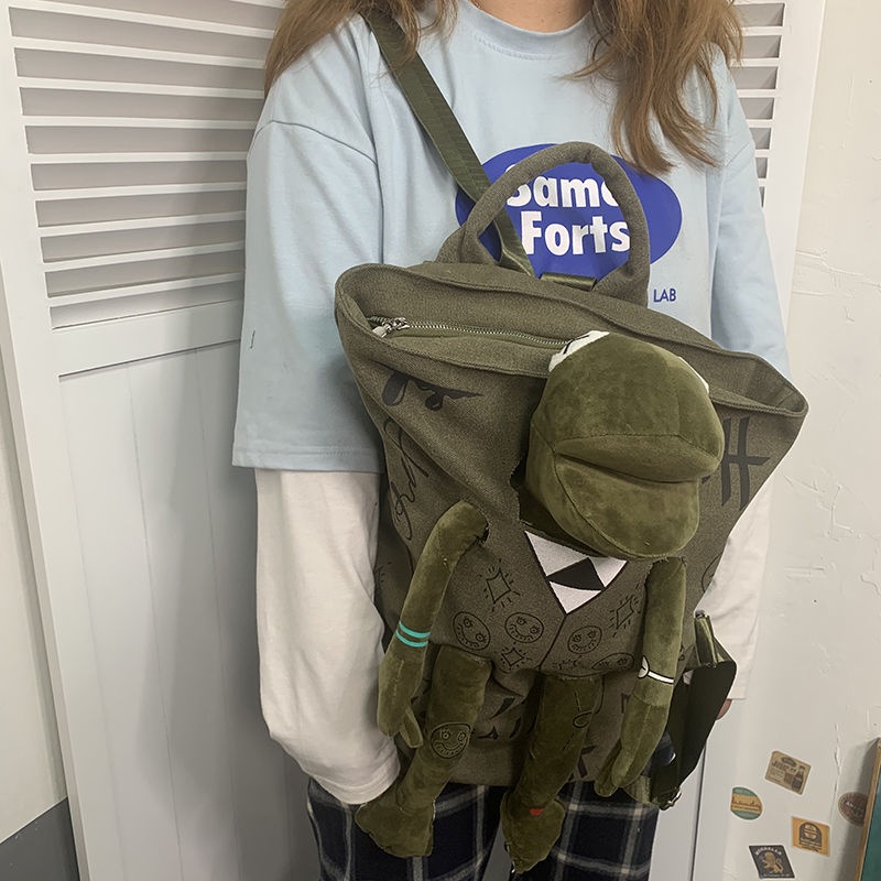 ✘♘✆Sera Jepang Street Cool Graffiti Seri Ransel Kanvas Gaya Hong Kong Sastra Katak Merek Tas Sekolah Boneka