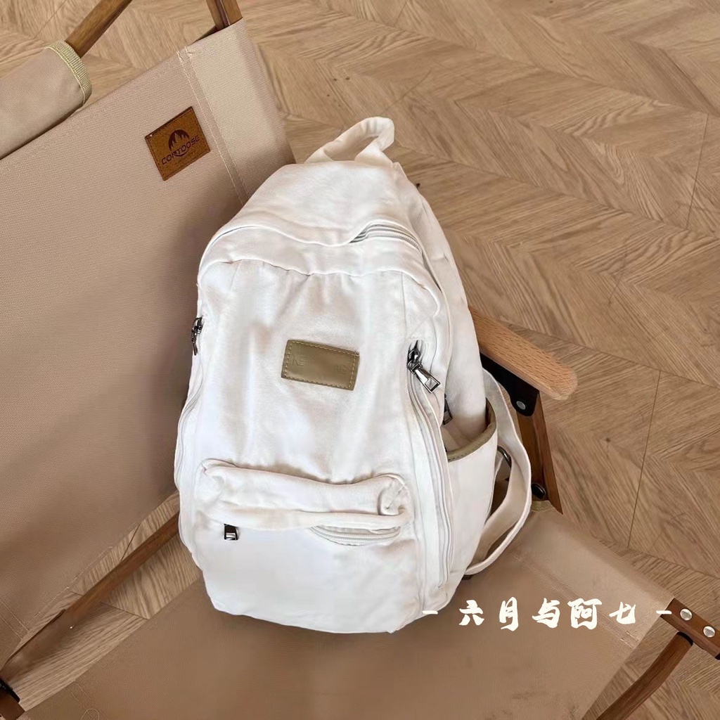 ✒♝Sera Sera diimpor perguruan tinggi Jepang gaya malas tua dicuci putih kanvas tas sekolah siswa gaya sederhana liontin putih ransel kanvas