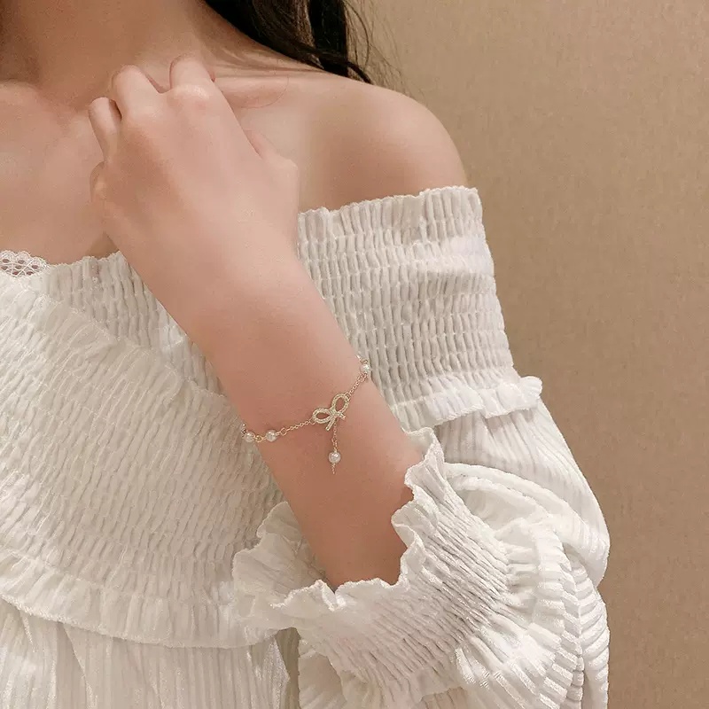 Roselife Gelang Tangan Gaya Korea Aksen Pita + Mutiara + Zircon Warna Gold Untuk Perhiasan Wanita