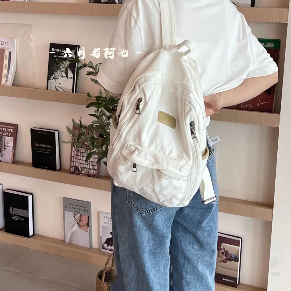 ✒♝Sera Sera diimpor perguruan tinggi Jepang gaya malas tua dicuci putih kanvas tas sekolah siswa gaya sederhana liontin putih ransel kanvas