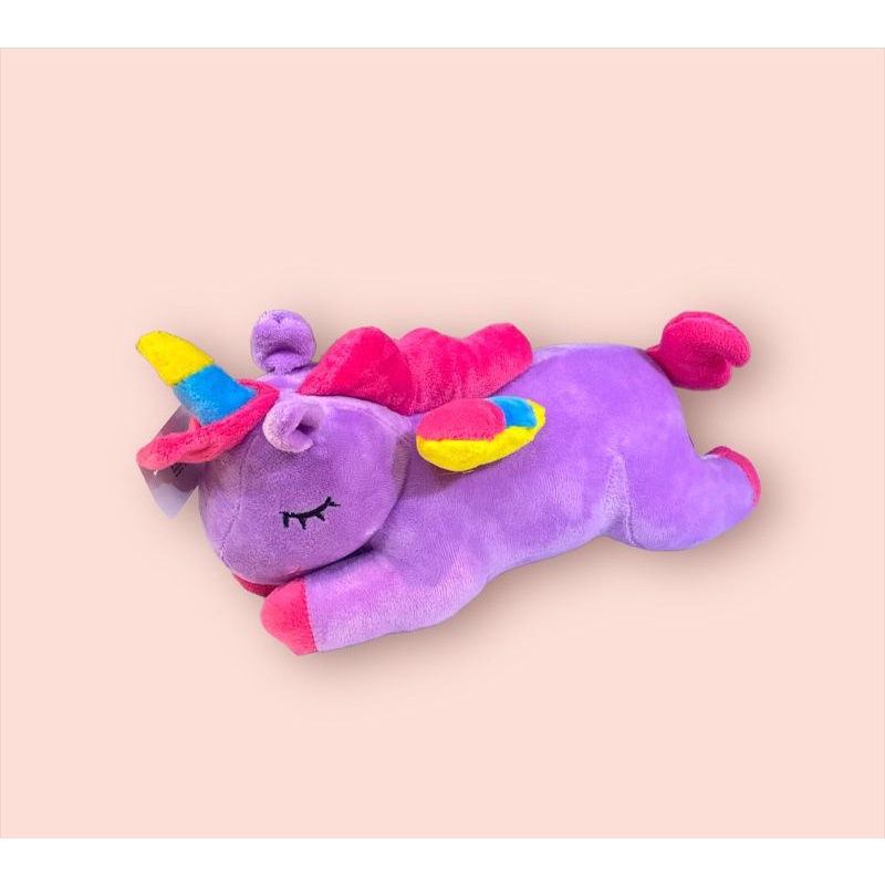 boneka unicorn lying