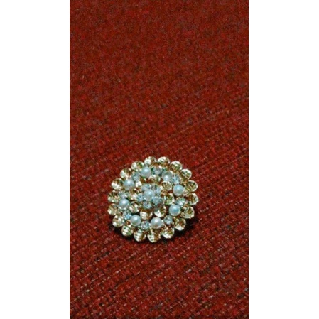 bross jilbab motif bunga bulat