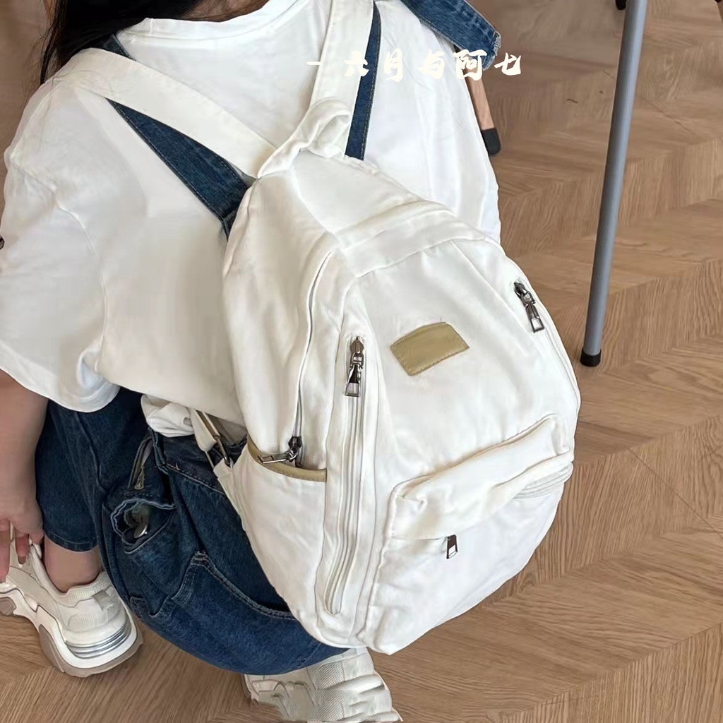 ✒♝Sera Sera diimpor perguruan tinggi Jepang gaya malas tua dicuci putih kanvas tas sekolah siswa gaya sederhana liontin putih ransel kanvas