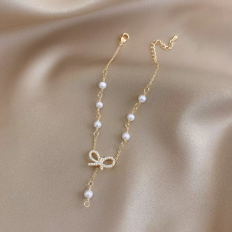 Roselife Gelang Tangan Gaya Korea Aksen Pita + Mutiara + Zircon Warna Gold Untuk Perhiasan Wanita