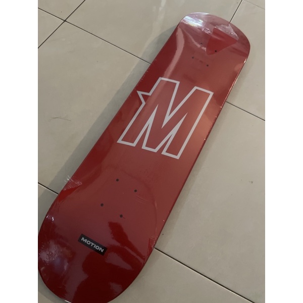 motion team logo red skateboard deck