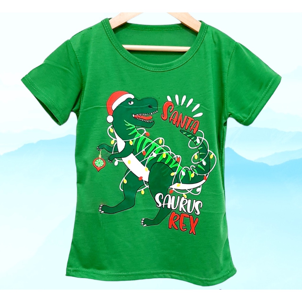 Kaos natal anak perempuan atau laki-laki motif trex santa lengan pendek  bahan lembut dan adem/ Kaos natal anak dinosaurus trex santa terbaru harga murah