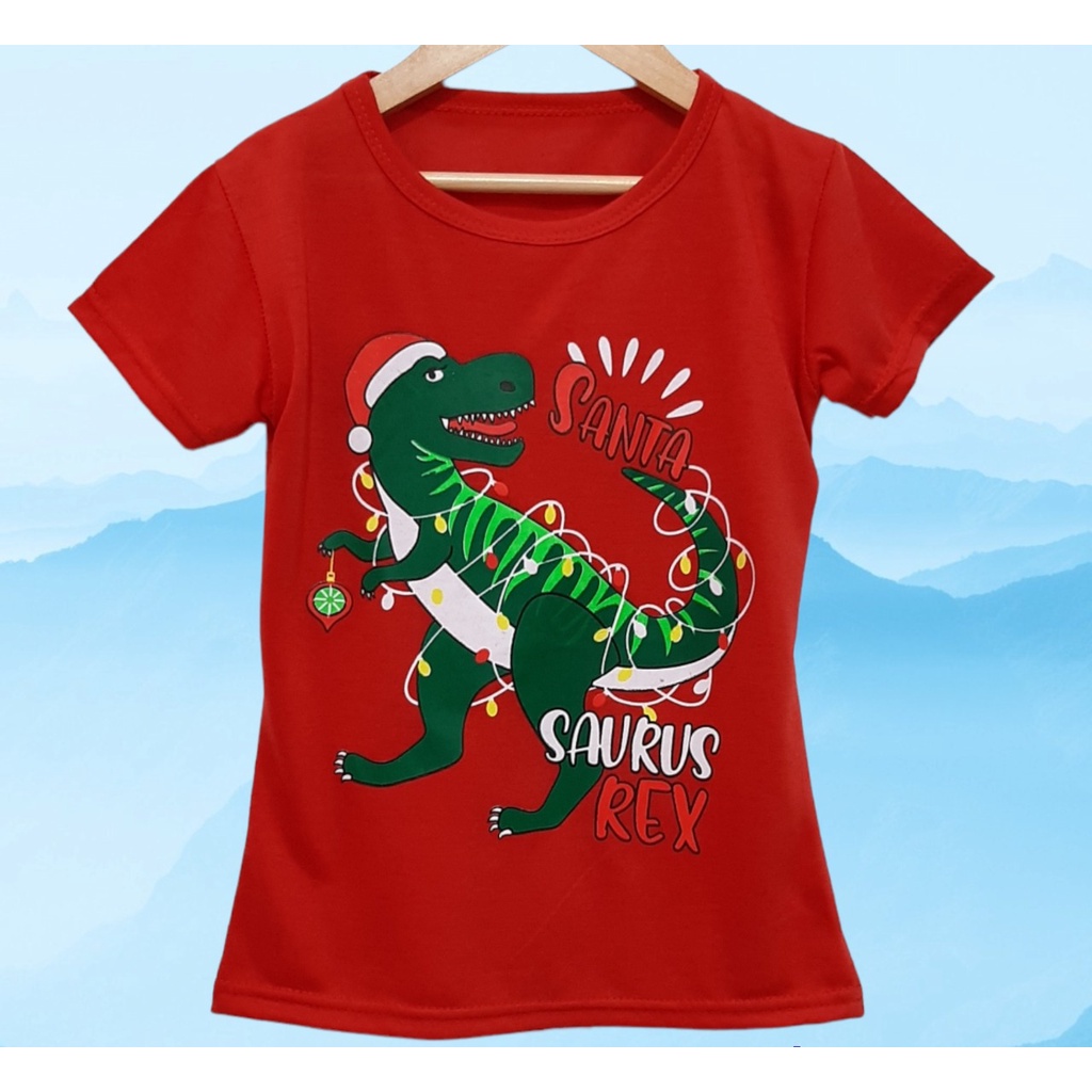 Kaos natal anak perempuan atau laki-laki motif trex santa lengan pendek  bahan lembut dan adem/ Kaos natal anak dinosaurus trex santa terbaru harga murah