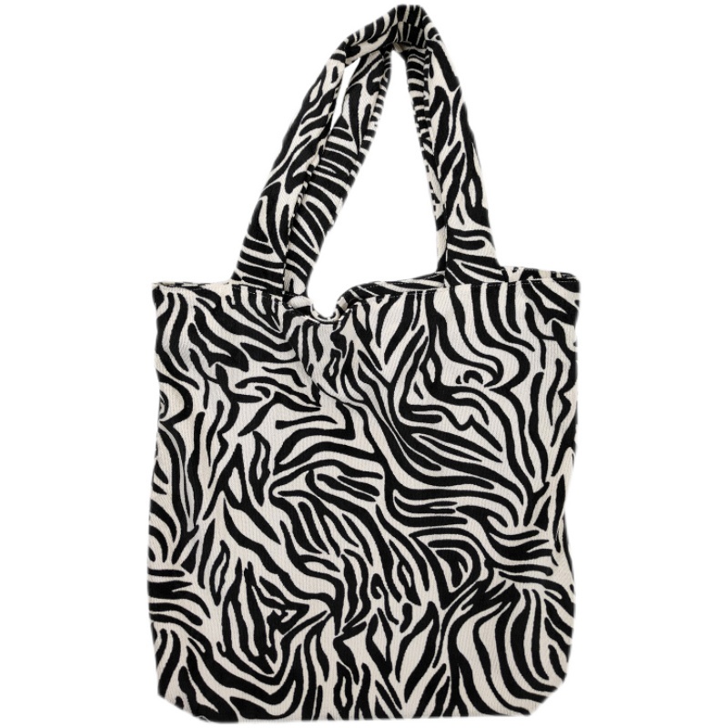 ▫▤Sera zebra pattern canvas bag female 2022 new tote bag design niche student class large capacity shoulder bag