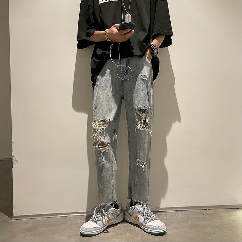 Celana panjang pria longgar all-match trendi gaya Korea celana sobek sembilan poin celana jeans luru