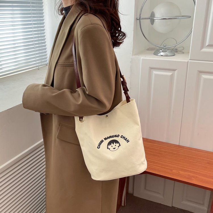 ♧✆❀Sera  Nanfeng co-branded dreamer bucket bag pekerja kantor single shoulder Messenger tas kanvas wajah tersenyum niche tas wanita all-match