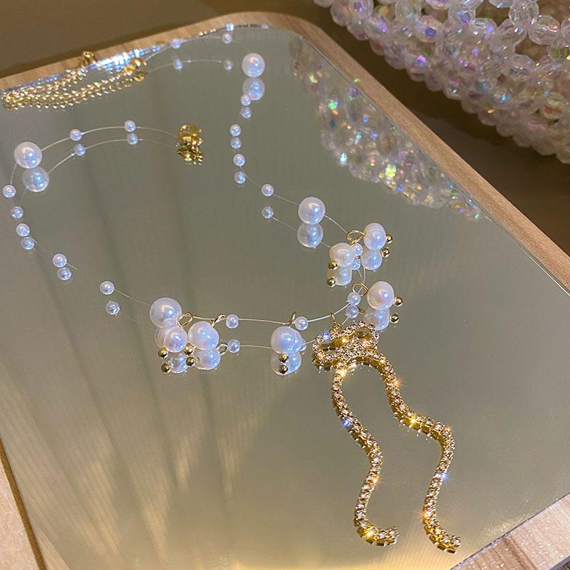 Kalung Mutiara Rantai Transparan dengan Liontin Pita Kristal