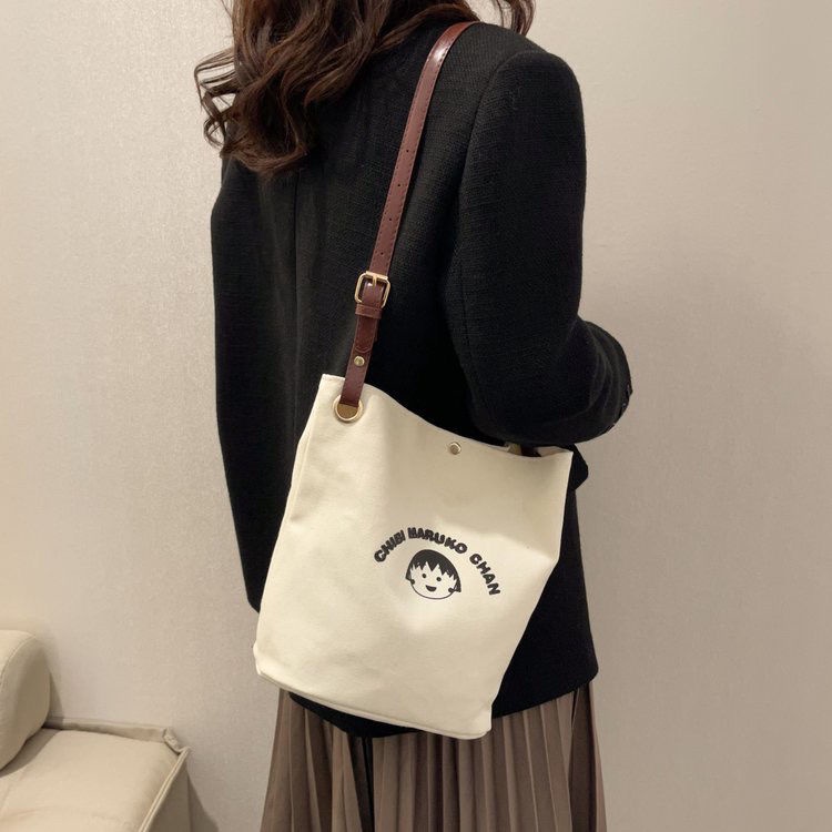 ♧✆❀Sera  Nanfeng co-branded dreamer bucket bag pekerja kantor single shoulder Messenger tas kanvas wajah tersenyum niche tas wanita all-match