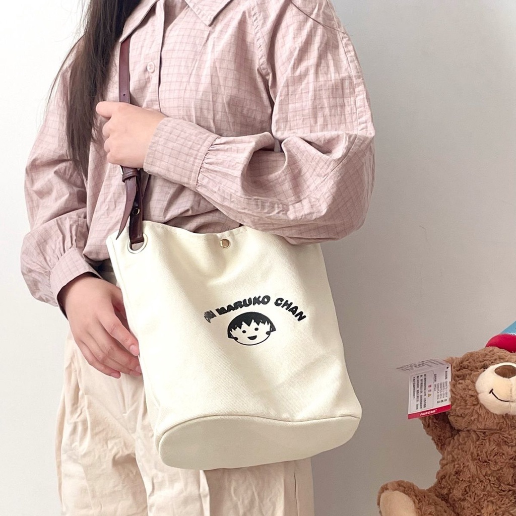 ♧✆❀Sera  Nanfeng co-branded dreamer bucket bag pekerja kantor single shoulder Messenger tas kanvas wajah tersenyum niche tas wanita all-match