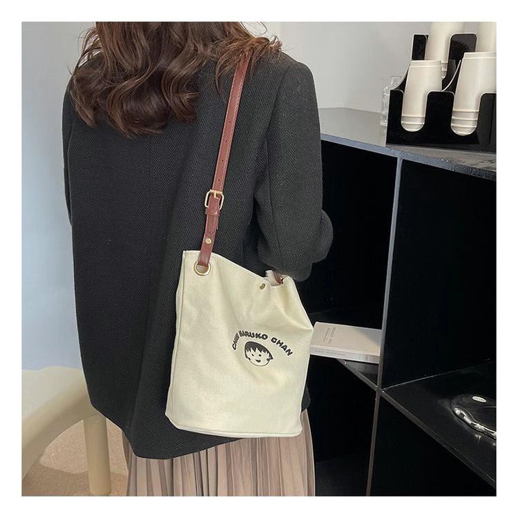 ♧✆❀Sera  Nanfeng co-branded dreamer bucket bag pekerja kantor single shoulder Messenger tas kanvas wajah tersenyum niche tas wanita all-match