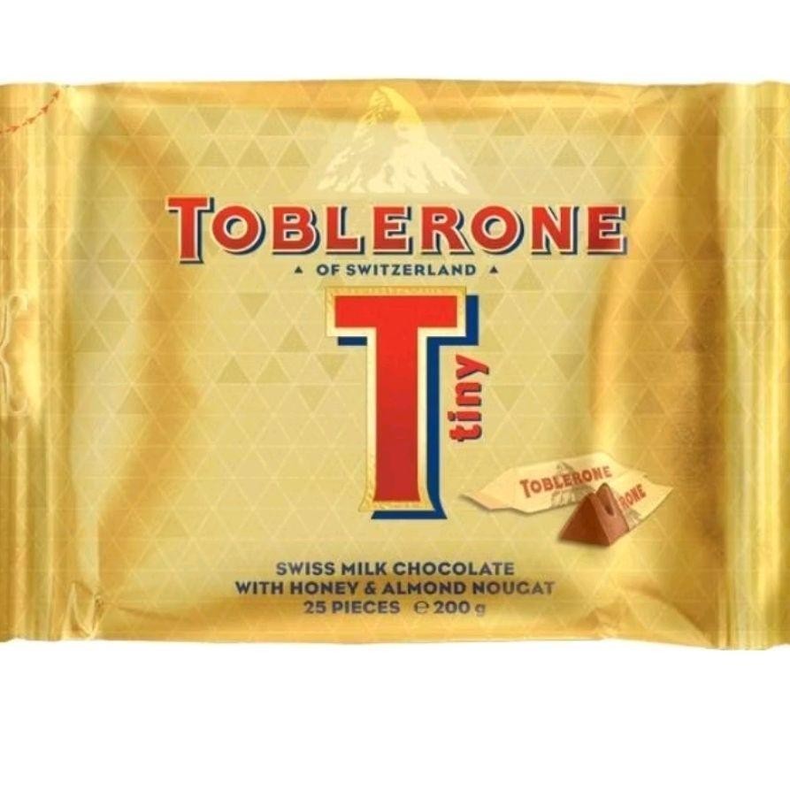 

Toblerone Tiny Swiss Milk Chocolate With Honey & Almond Nougat Coklat Import 200gr