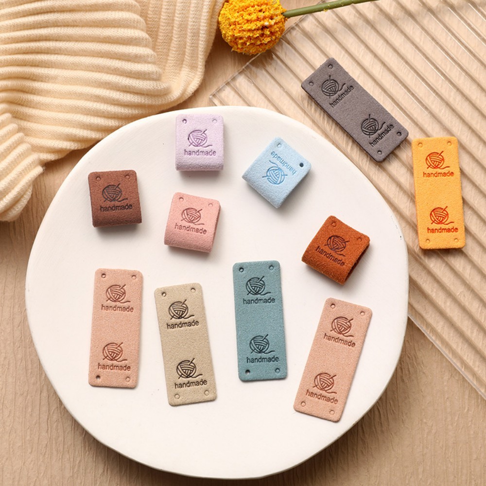 

50pcs 2x5cm Folded Embossed Suede Tags - Pom-Pom Accent Leather Labels for Hats & Apparel | Handmade Craft Supply