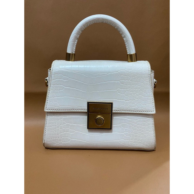 Preloved tas ck putih broken white Charles & Keith Trapeze Printed Croco Top Handle bag