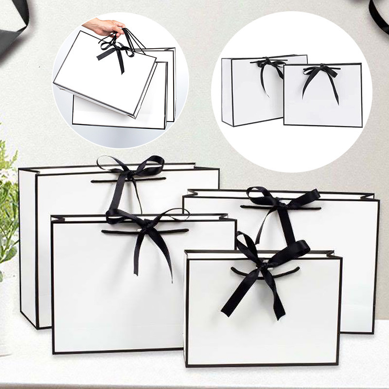 

Modern Simple Black Frame White Cardboard Gift Bag Foldable Hand-Held Clothes Gift Packaging Bag Bow Gift Packaging Bag
