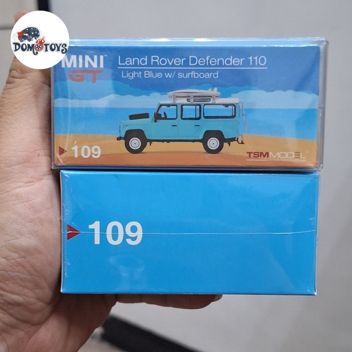 Mini GT Skala 64 Land Rover Defender 110 Light Blue Surfboard Edition #109