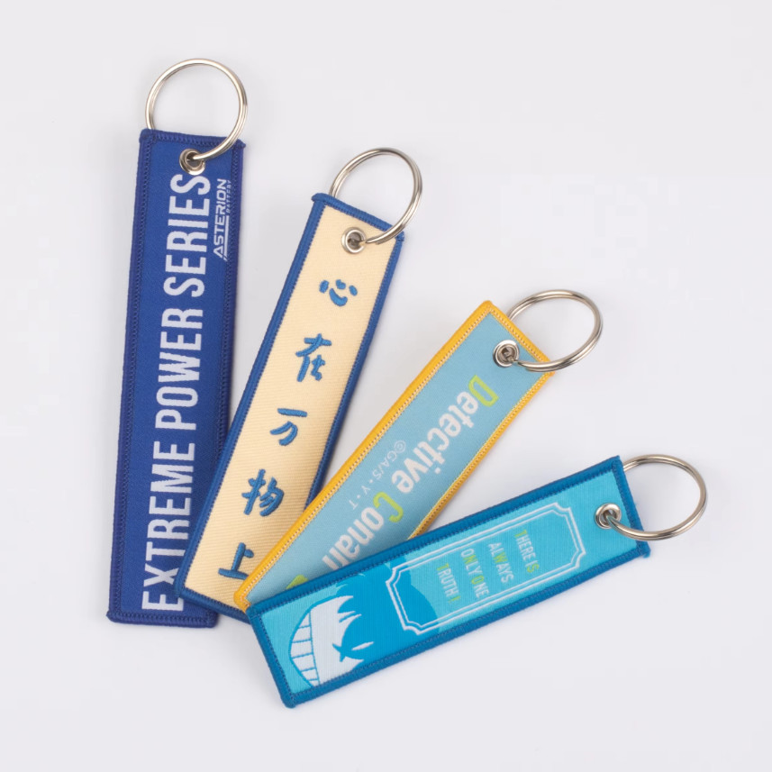 

Custom Promotional Logo Remove Before a Flight Crew Double Sided Woven Fabric Embroidered Key Jet Tag Keychain