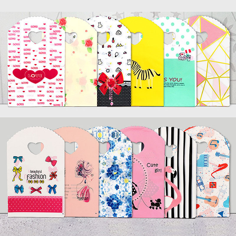 

50pcs/lot Various Patterns Jewelry Plastic Bag Heart-Shaped Oval Handles Mini Gift Packing Bag Store Small Shopping Bags