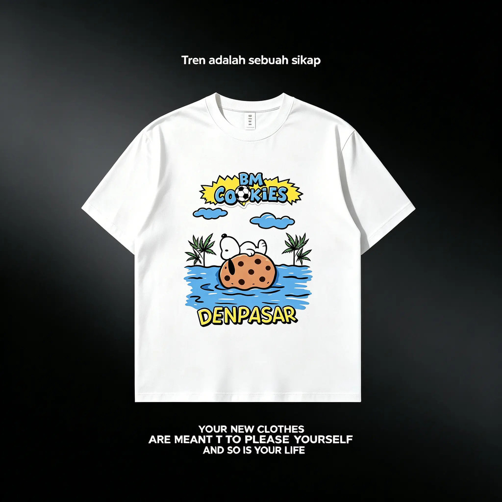 Kaos dengan ilustrasi Snoopy bersantai di pulau kue, tulisan BM Cookies Denpasar bergaya liburan Bal