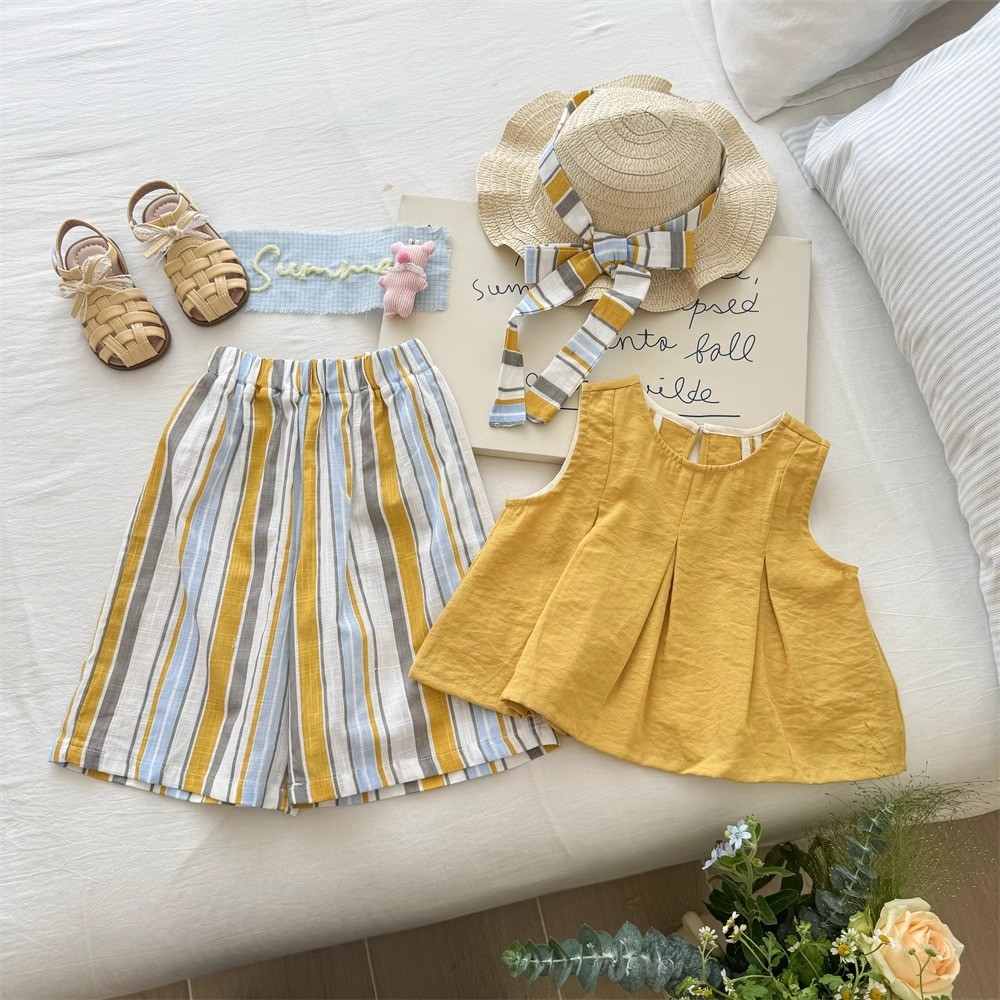 Pakaian musim panas yang lucu untuk bayi perempuan: setelan kemeja boneka dan celana bergaris.