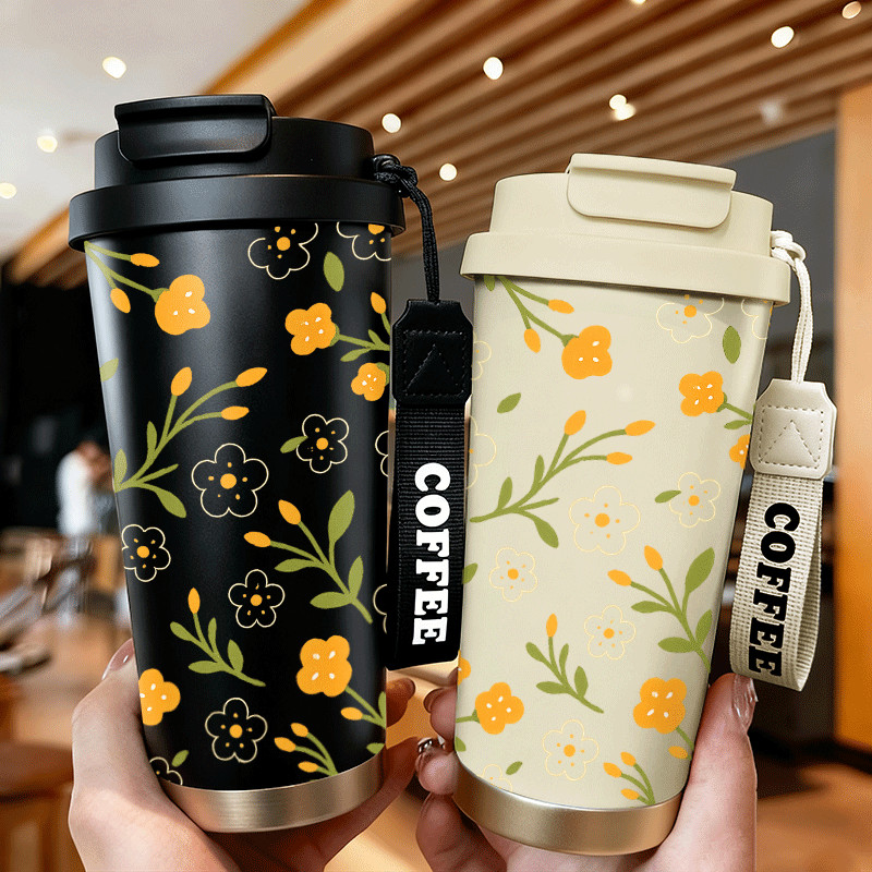 Gugusan bunga kecil berwarna oranye dan putihGelas termos baja tahan karat, cocok untuk minuman pana