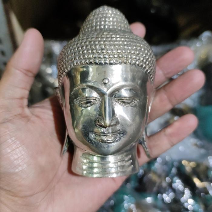 patung kepala buddha logam