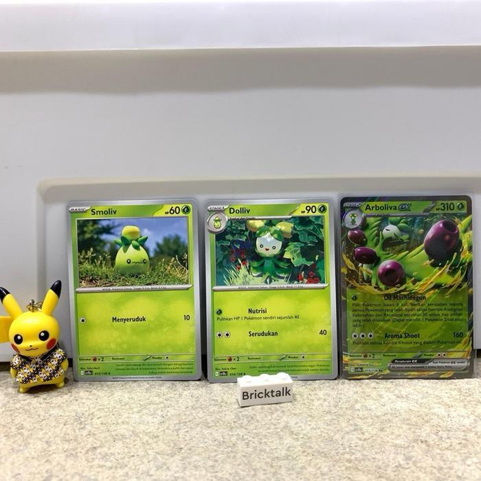 TCG SV10S Smoliv 013/138 C, Dolliv 014/138 C, Arboliva EX RR 015/138, Kehadiran Juara team Rocket
